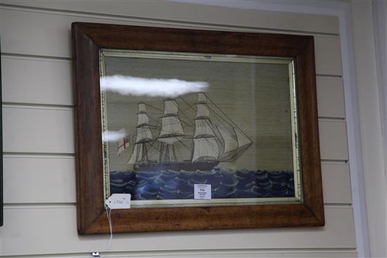 A Victorian woolwork picture of a ship at full sail, 22.75in.